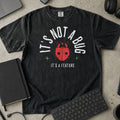 It's Not a Bug It's a Feature Shirt in Black, Comfort Colors 1717 tee flat lay