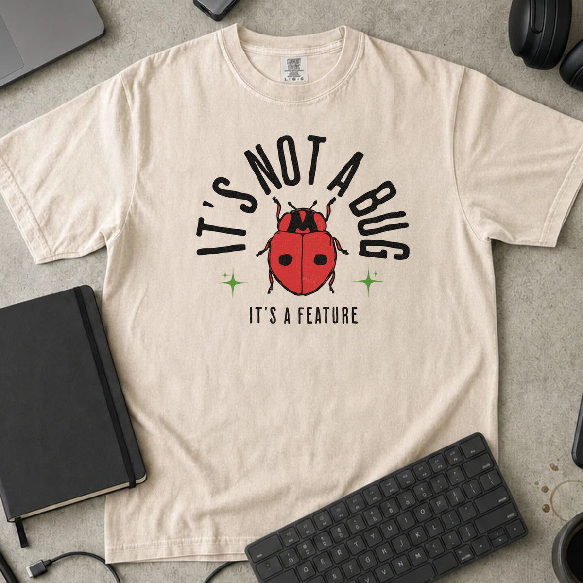 It's Not a Bug It's a Feature Shirt in Ivory, Comfort Colors 1717 tee flat lay