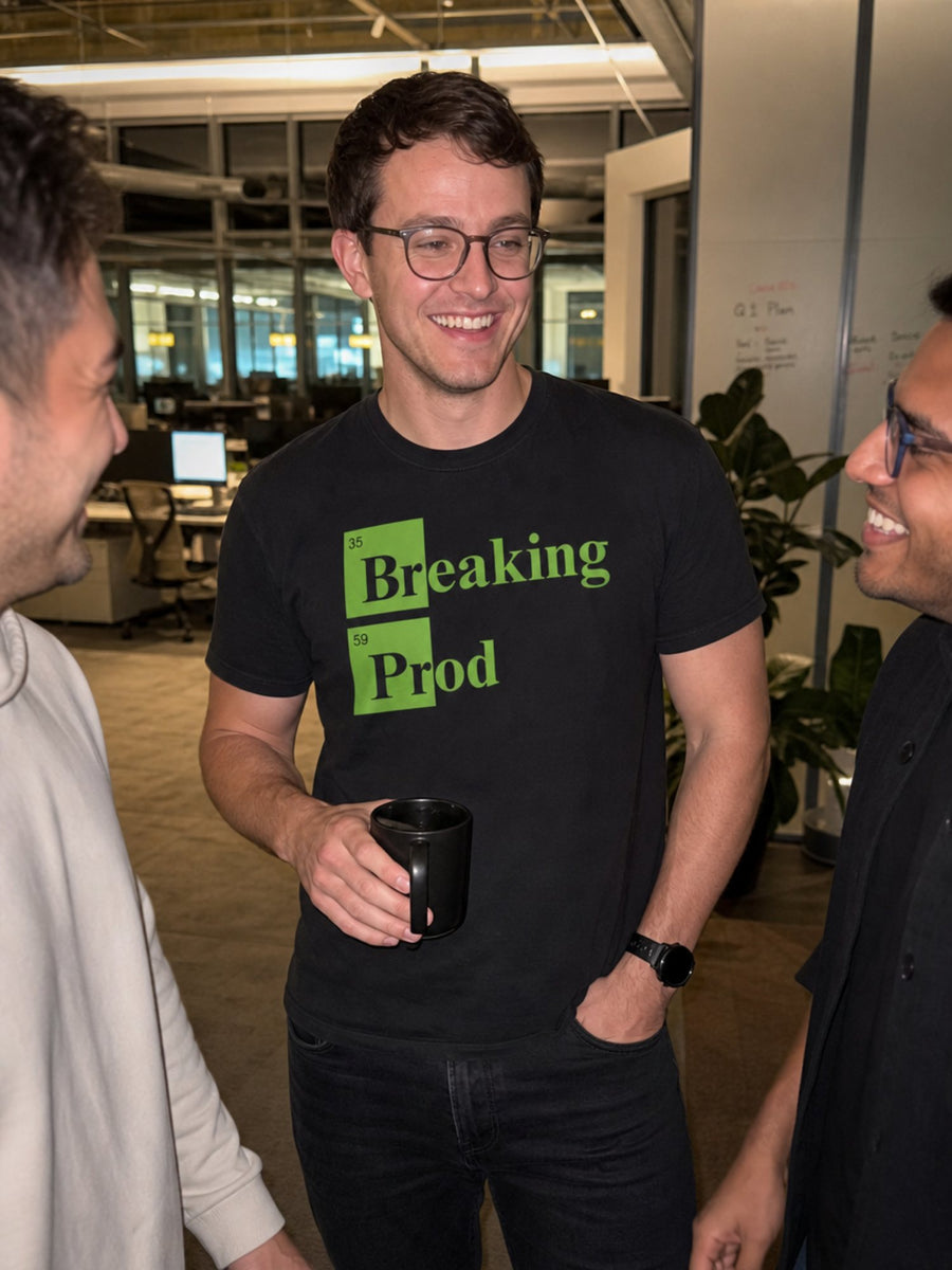 Developer smiling in the black Breaking Prod tee