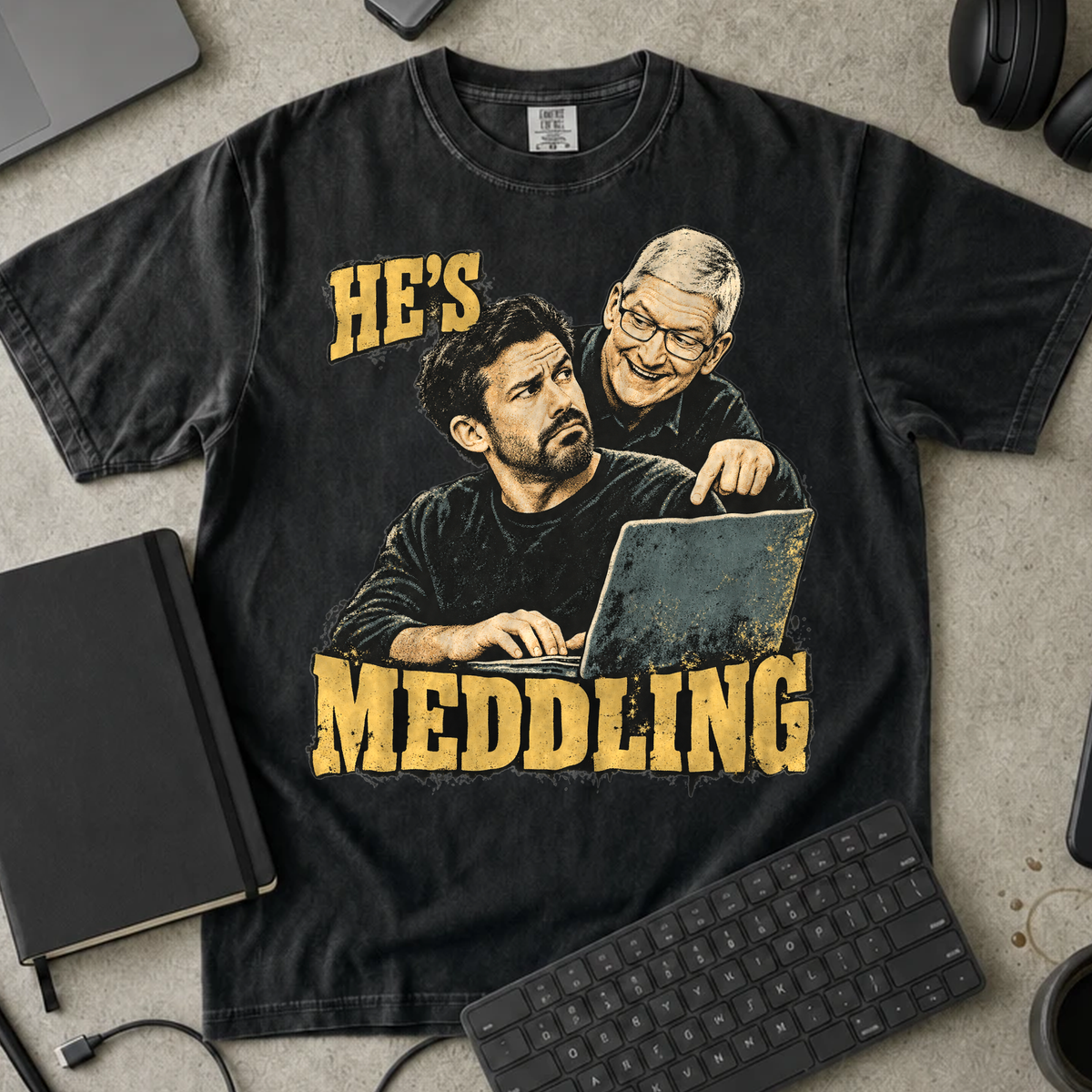 He's Meddling Shirt — Black Comfort Colors 1717 flat lay