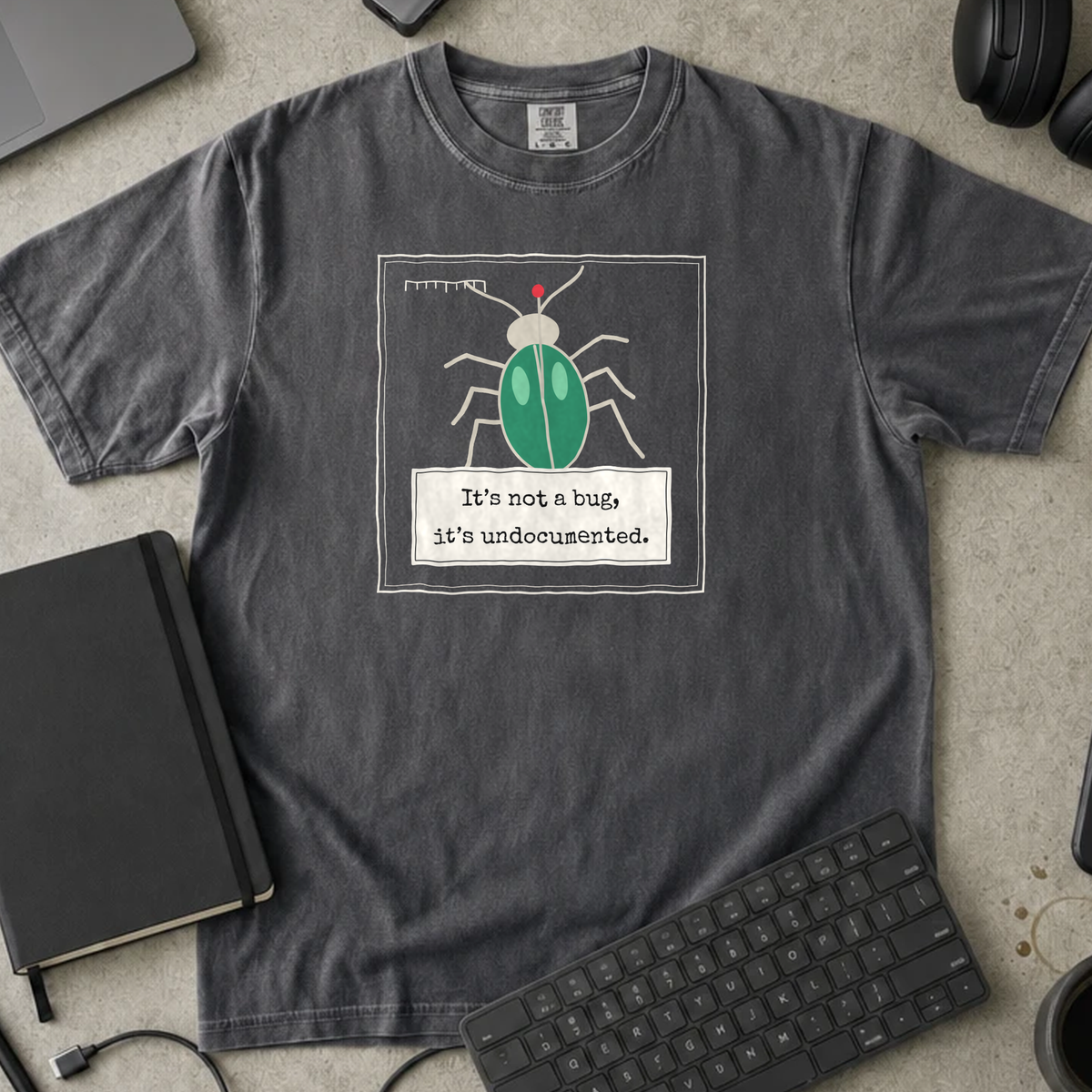 It's Not a Bug It's Undocumented Shirt — Pepper Comfort Colors 1717 flat lay
