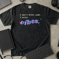 I Don't Write Code I Write Vibes Shirt — Black Comfort Colors 1717 flat lay