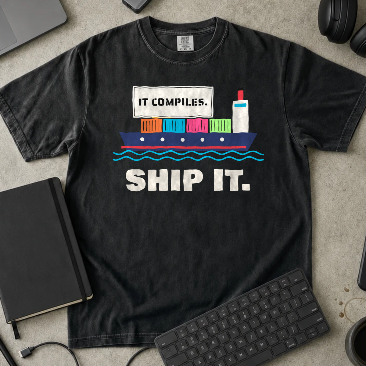 It Compiles Ship It Shirt — Black Comfort Colors 1717 flat lay