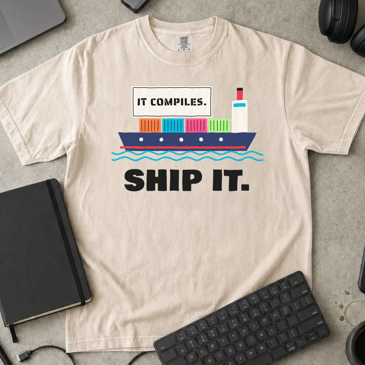 It Compiles Ship It Shirt — Ivory Comfort Colors 1717 flat lay