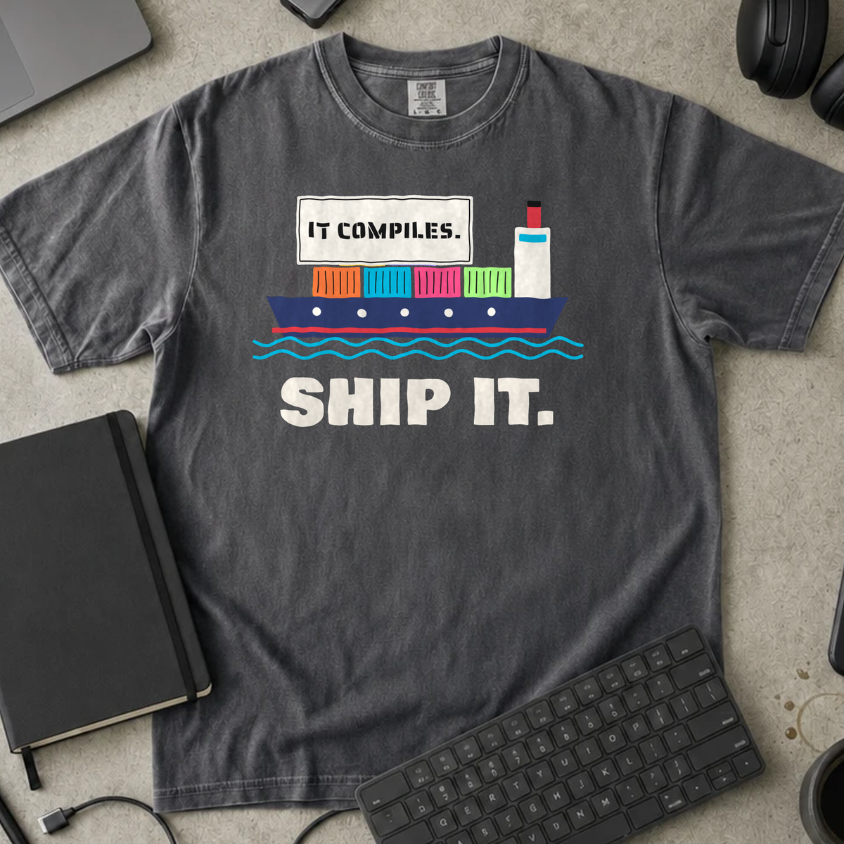 It Compiles Ship It Shirt — Pepper Comfort Colors 1717 flat lay